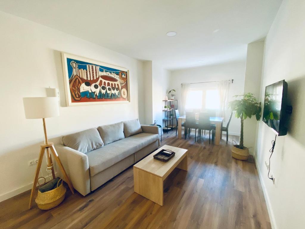 a living room with a couch and a table at GMC Turistics - La Casa de los Álamos in Málaga