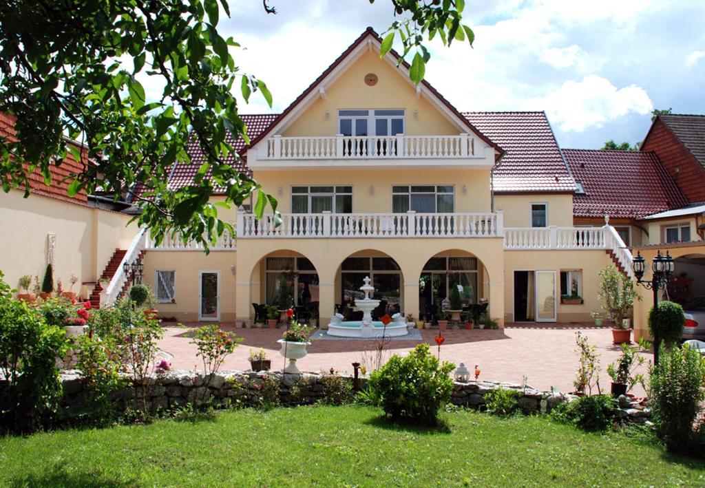 a large house with a patio and a yard at Haus Toskana in Bad Frankenhausen