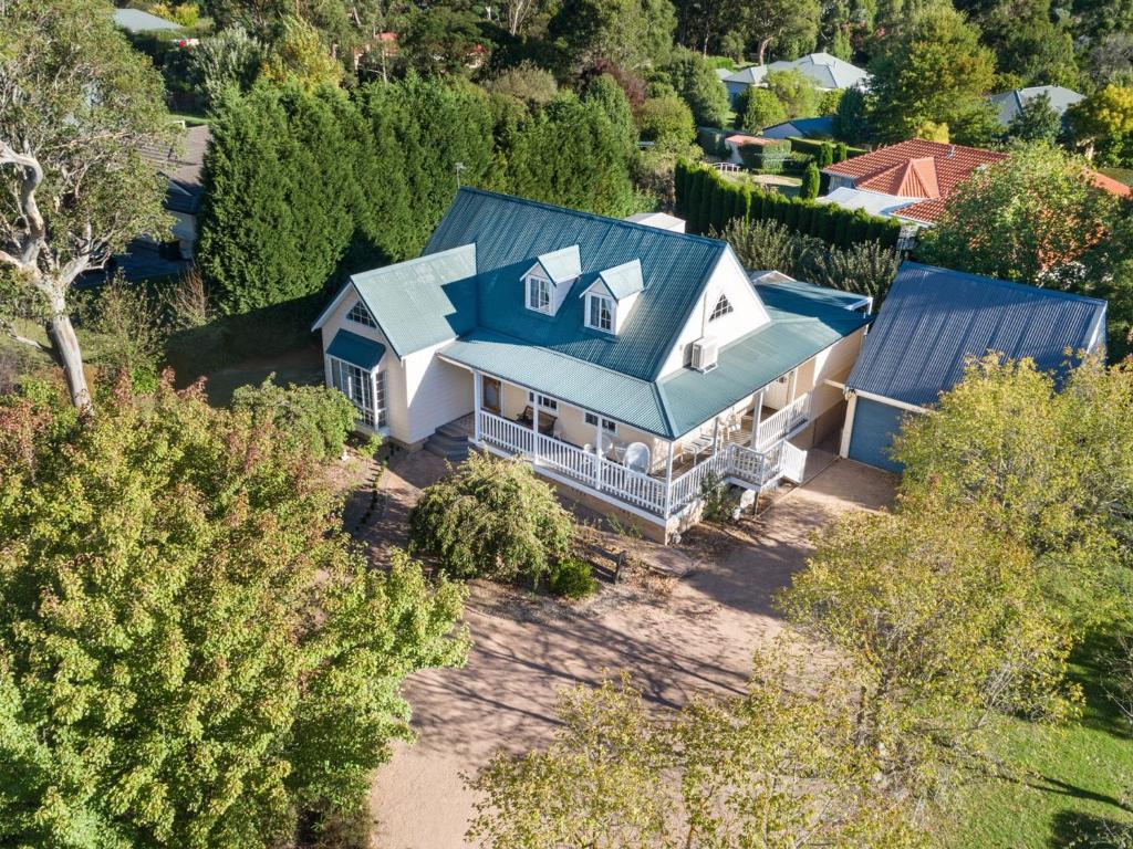 an aerial view of a house with a blue roof at Lou Lous Cottage Bowral Southern Highlands in Bowral