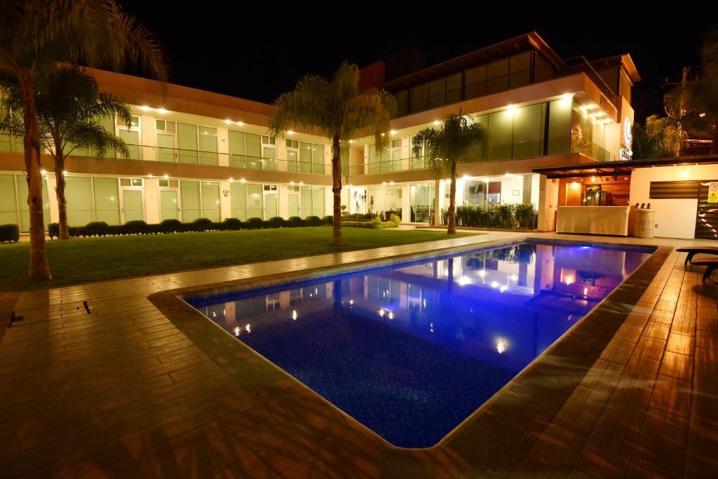 a swimming pool in front of a house at night at Hotel Quinta Tequisquiapan in Tequisquiapan