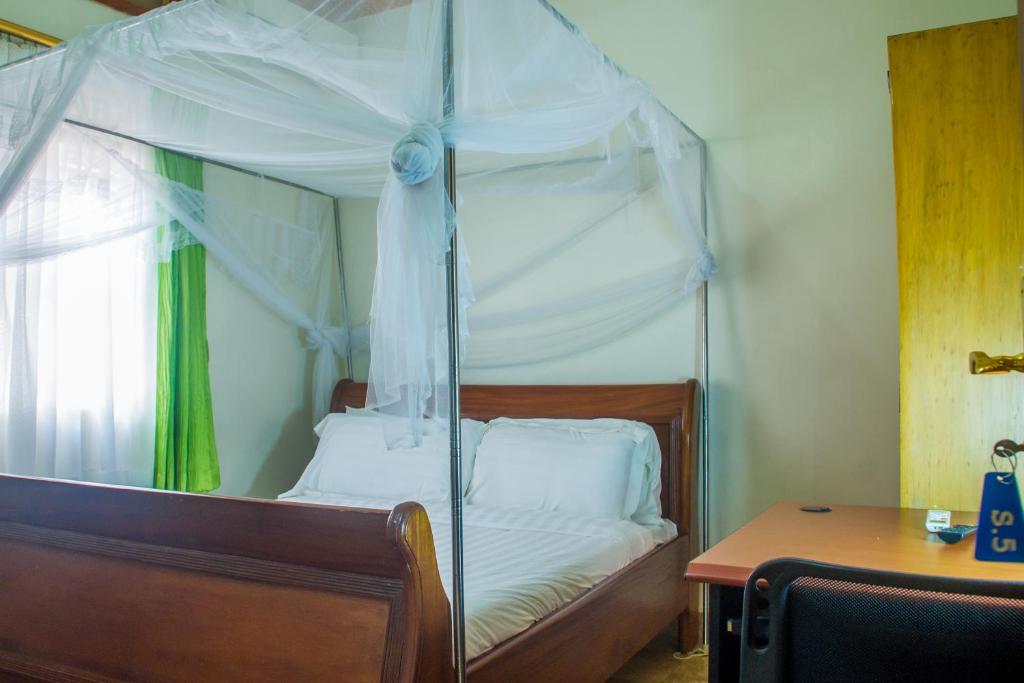 Postel nebo postele na pokoji v ubytování Sandton Hotel Kasese