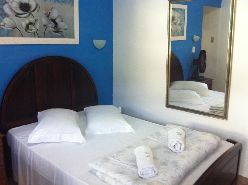 Ένα ή περισσότερα κρεβάτια σε δωμάτιο στο Pousada Ciclo do Ouro