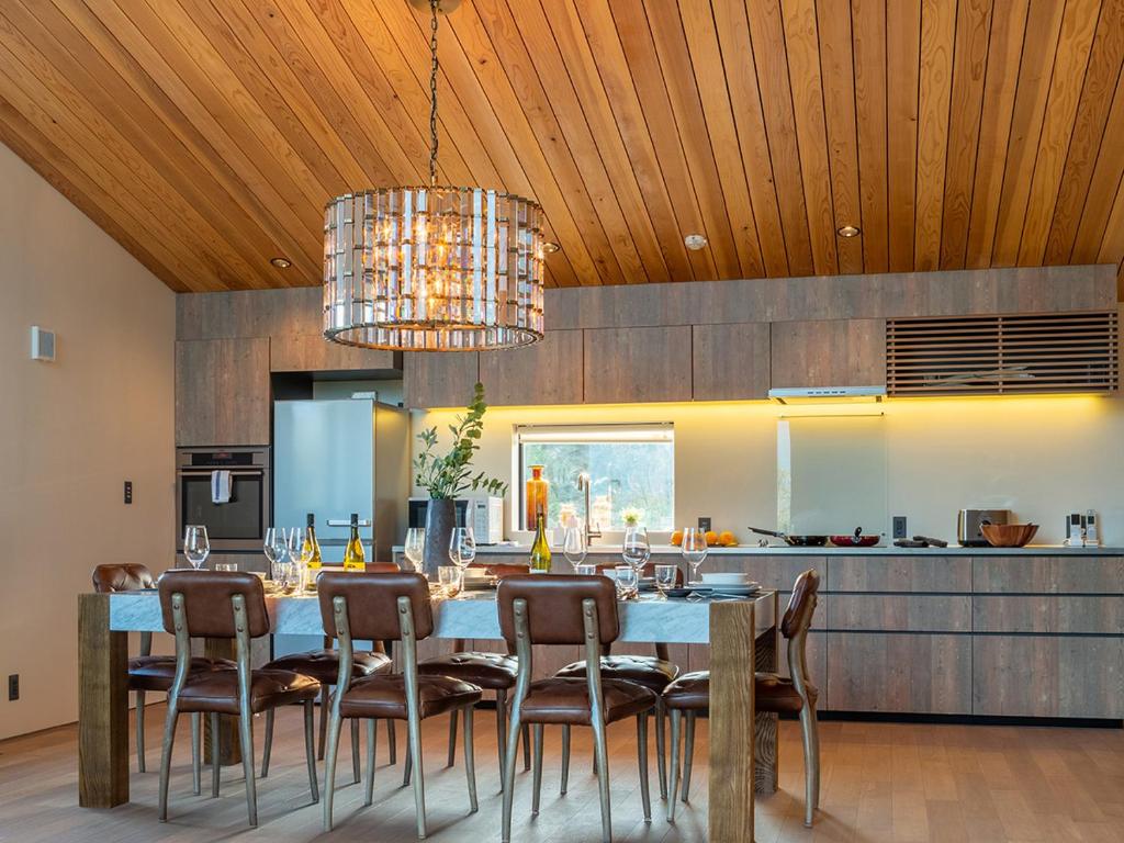 a dining room with a table and chairs in a kitchen at Foxwood D by H2 Life in Niseko