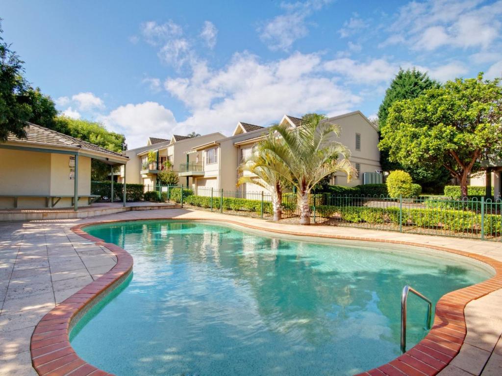 a swimming pool in front of a house at Spacious House with Balcony & Pool, Walks to Beach in Terrigal