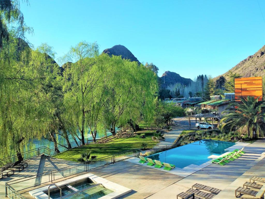 Vistas al complejo con piscina y árboles en Cabañas del Cerro en Valle Grande