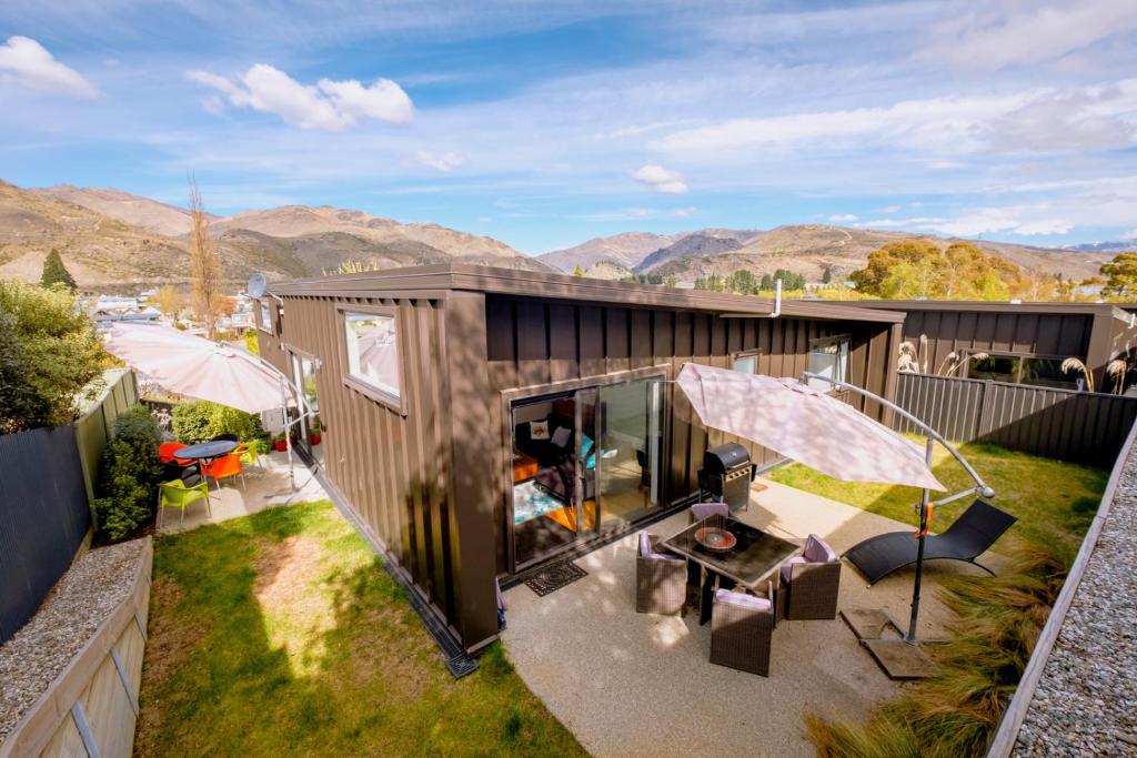 an aerial view of a house with mountains in the background at Kawerau River Retreat - Cromwell Holiday Home in Cromwell