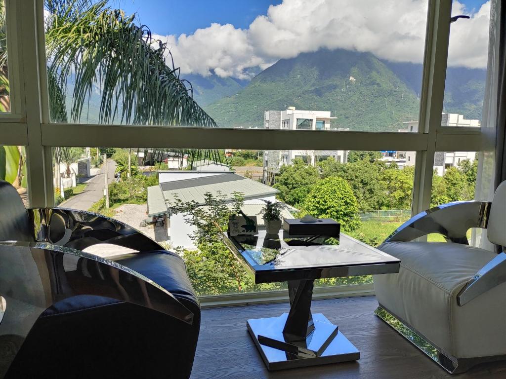 a room with a large window with a view of a mountain at White Palace B&amp;B in Ji&#39;an