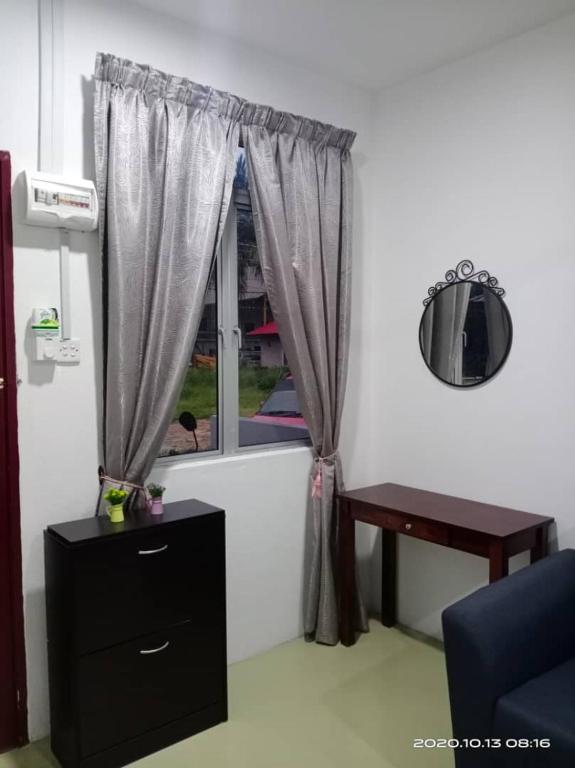 a room with a window with a table and a chair at Laman Hanaz - Homestay Aufa in Pantai Cenang
