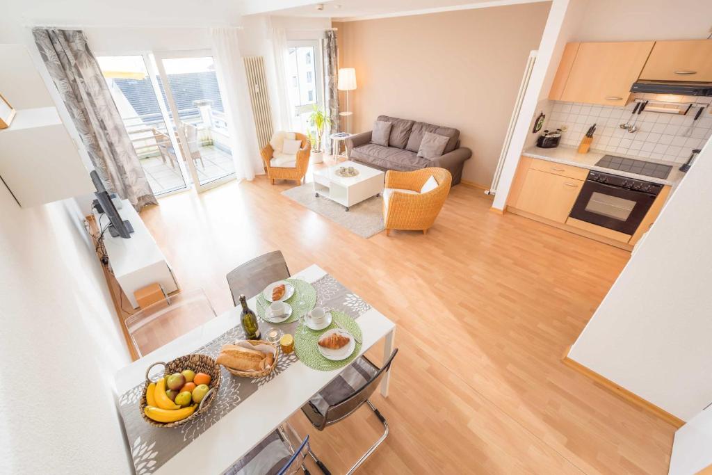 a kitchen and living room with a table with fruit on it at Penthouse STRANDDÜNE mit Meerblick in Sassnitz