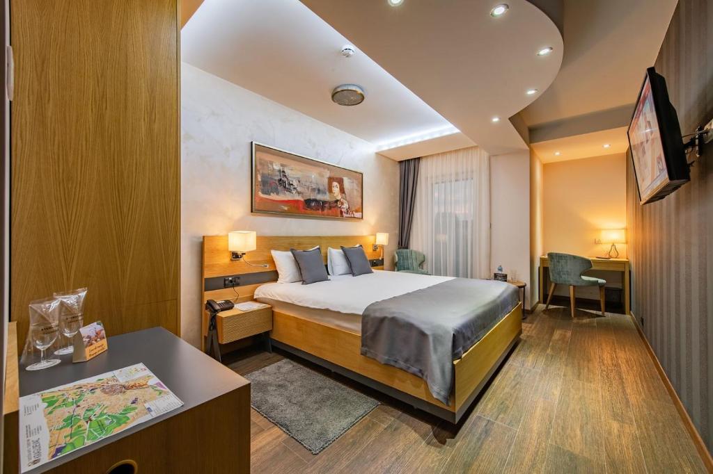 Postel nebo postele na pokoji v ubytování Rubicon Garni Hotel