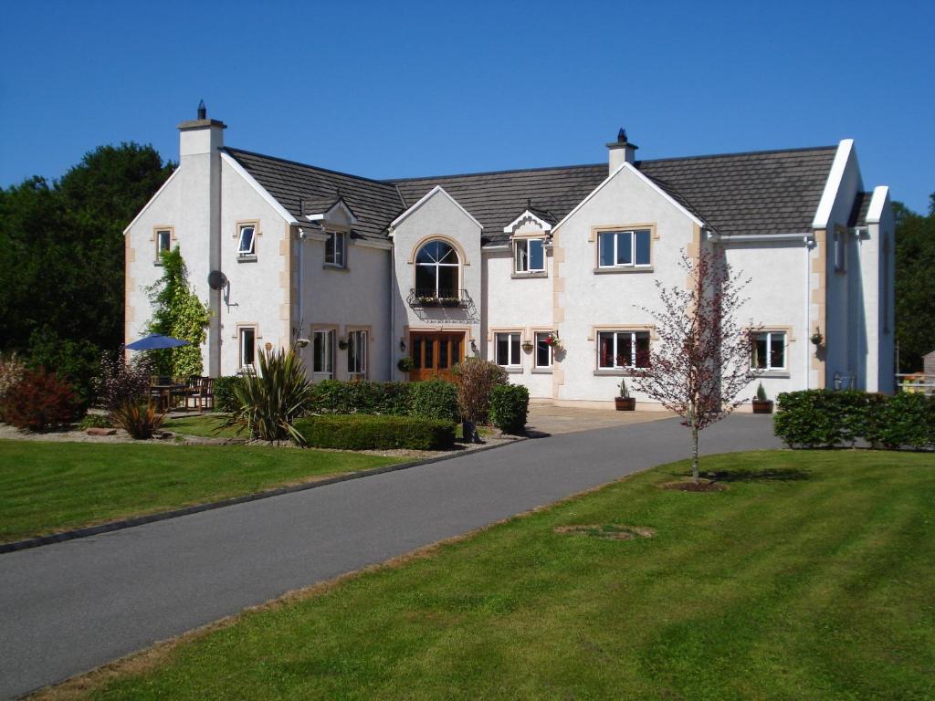 a large white house on a road at Dungimmon House in Ballyconnell