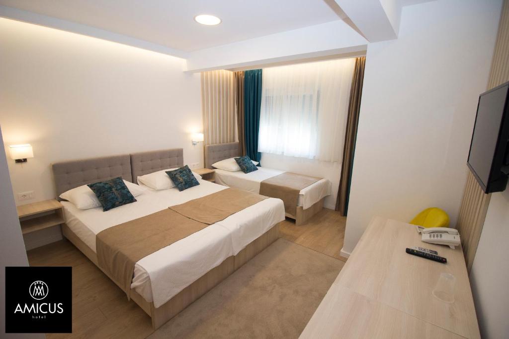 Postel nebo postele na pokoji v ubytování Hotel Amicus