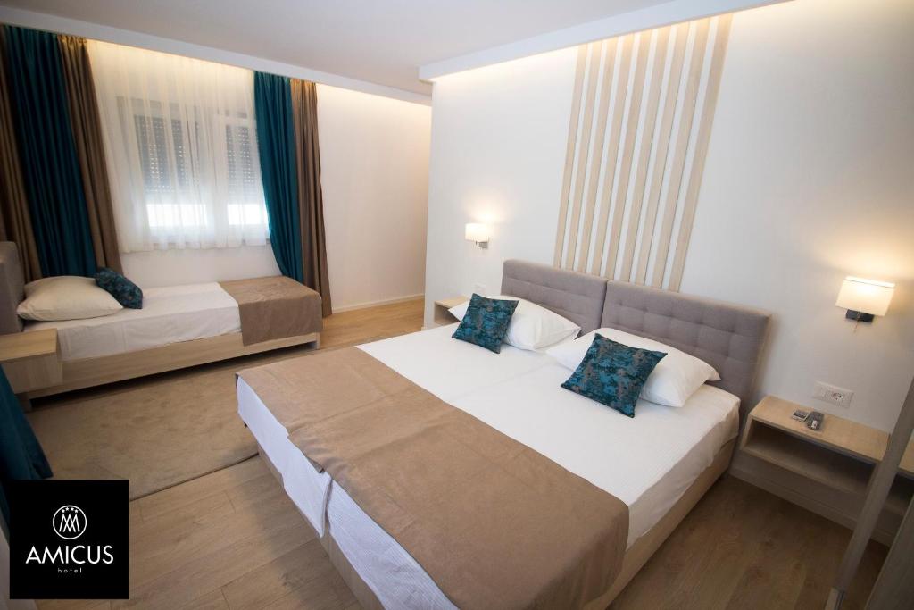 Postel nebo postele na pokoji v ubytování Hotel Amicus