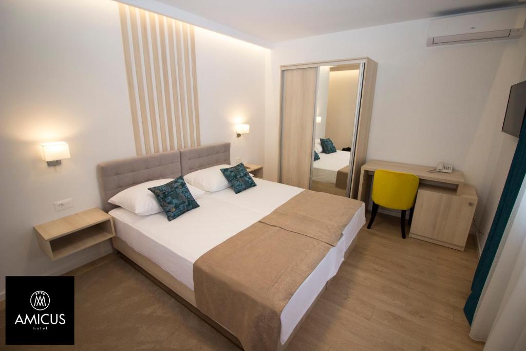 Postel nebo postele na pokoji v ubytování Hotel Amicus