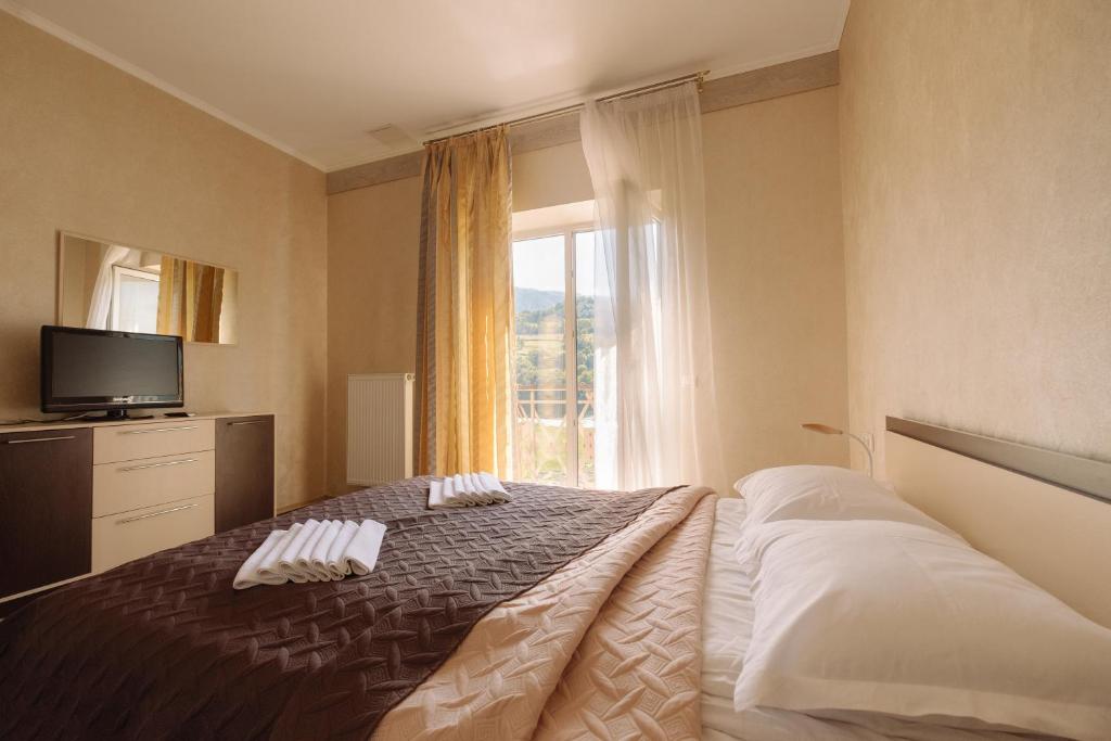 Postel nebo postele na pokoji v ubytování SPA Hotel Zhyva Voda