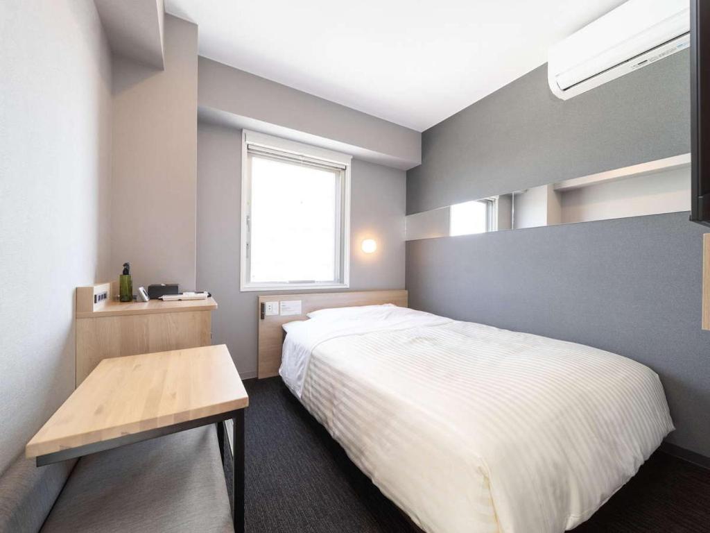 Postel nebo postele na pokoji v ubytování Super Hotel Tokyo Akabane Eki Minamiguchi