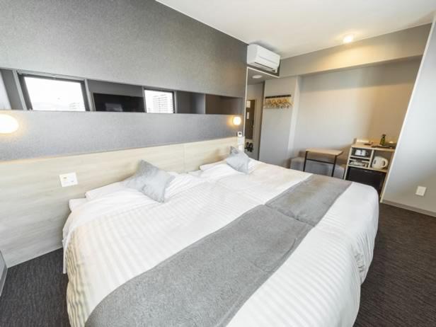 Postel nebo postele na pokoji v ubytování Super Hotel Tokyo Akabane Eki Minamiguchi