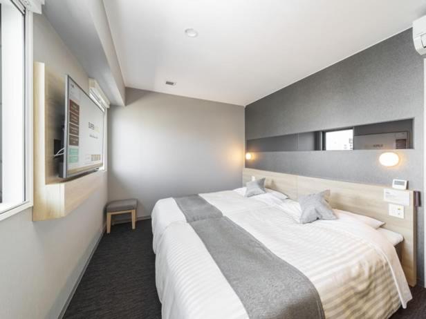 Postel nebo postele na pokoji v ubytování Super Hotel Tokyo Akabane Eki Minamiguchi