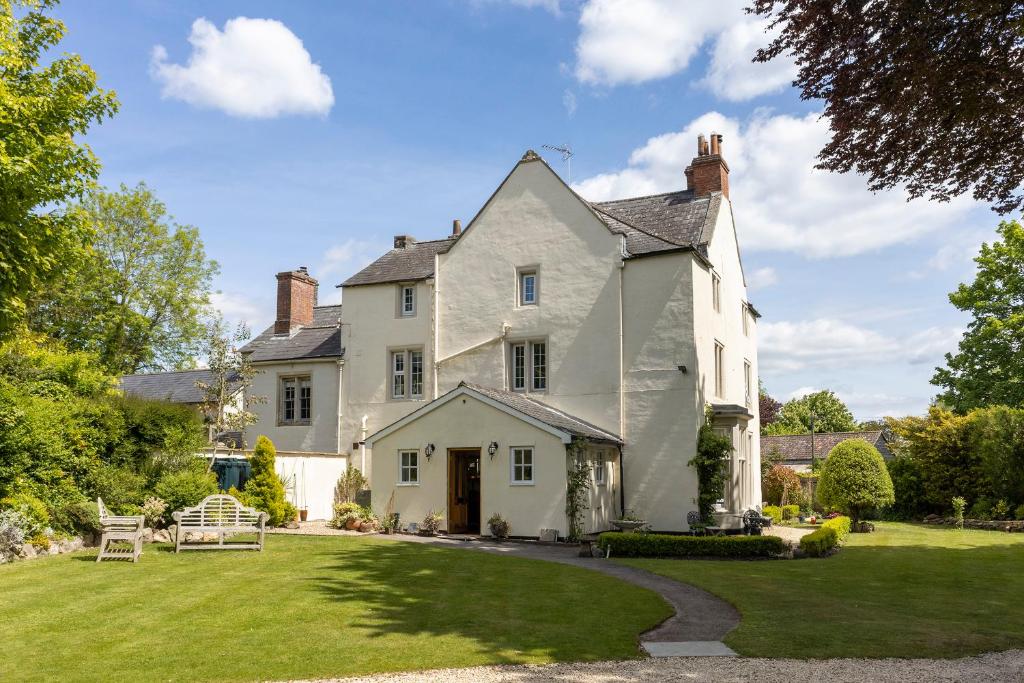 a large white house with a yard at The Old Rectory Chicklade in Chicklade