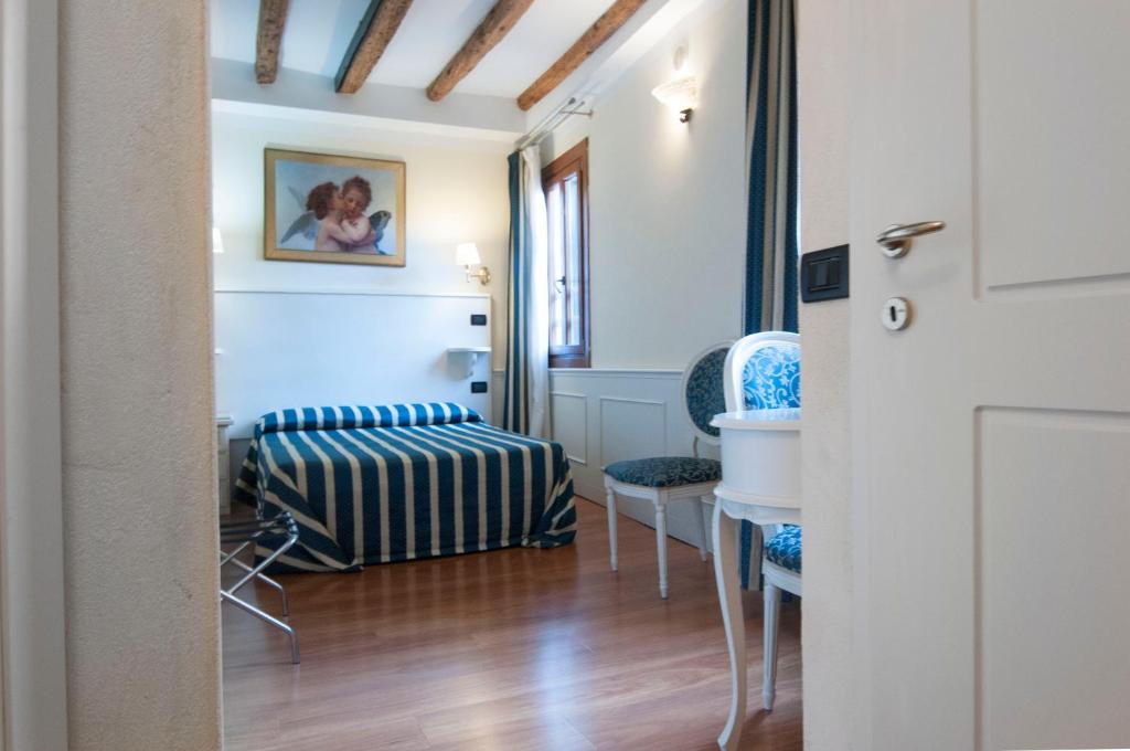 Postel nebo postele na pokoji v ubytování Venice Resorts Guest House