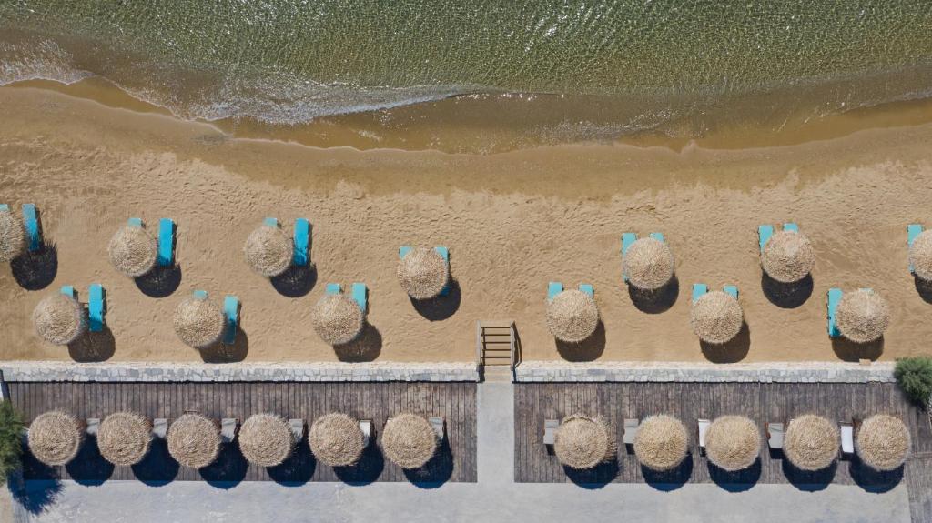 an overhead view of a sandy beach with chairs at Golden Beach Hotel in Chrissi Akti