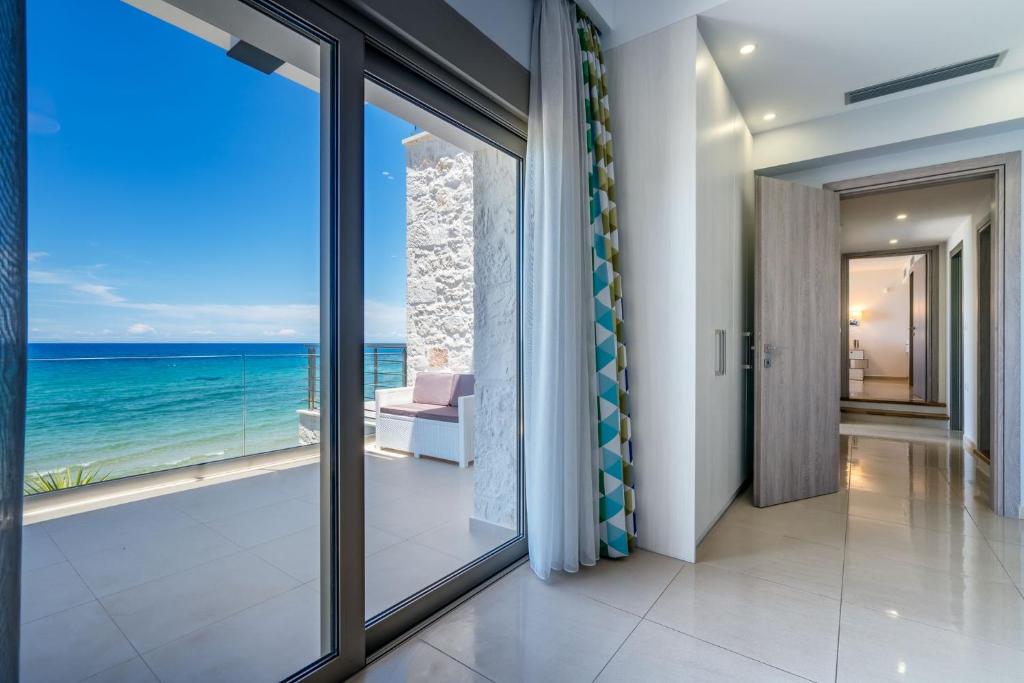 a hallway with a view of the ocean at Beachfront Zante Villa Villa Perla 5 Bedroom Private Pool Tragaki in Planos