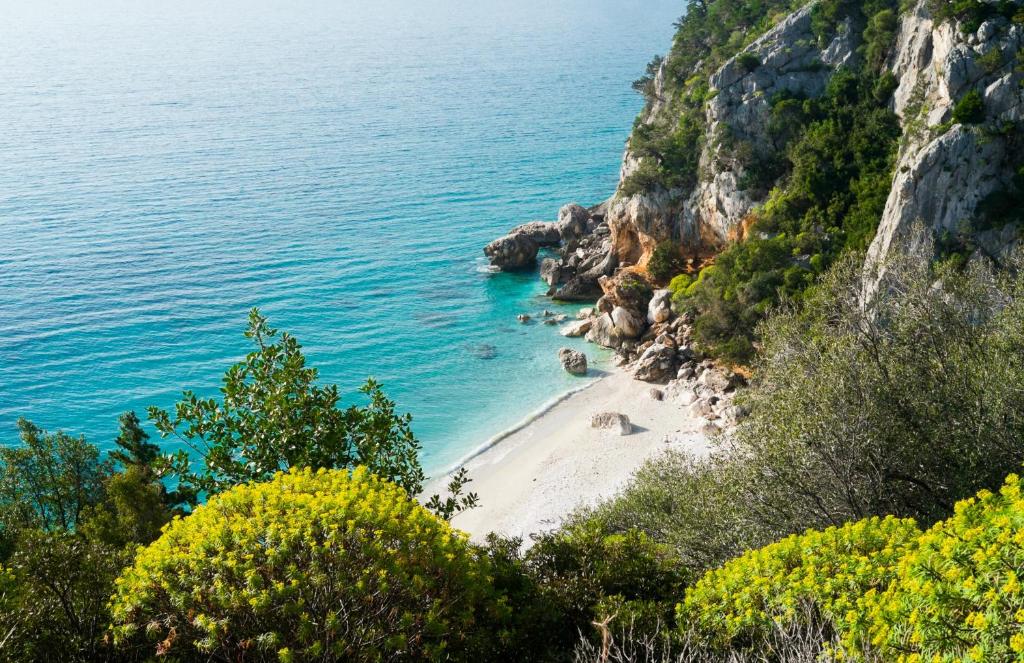 a beach on the side of a cliff at Appartamenti Manuela in Cala Gonone