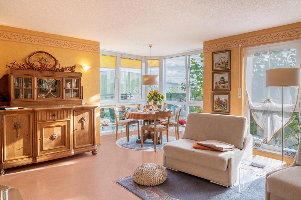 a living room with a chair and a table at Ferienwohnung Marianne in Radolfzell am Bodensee