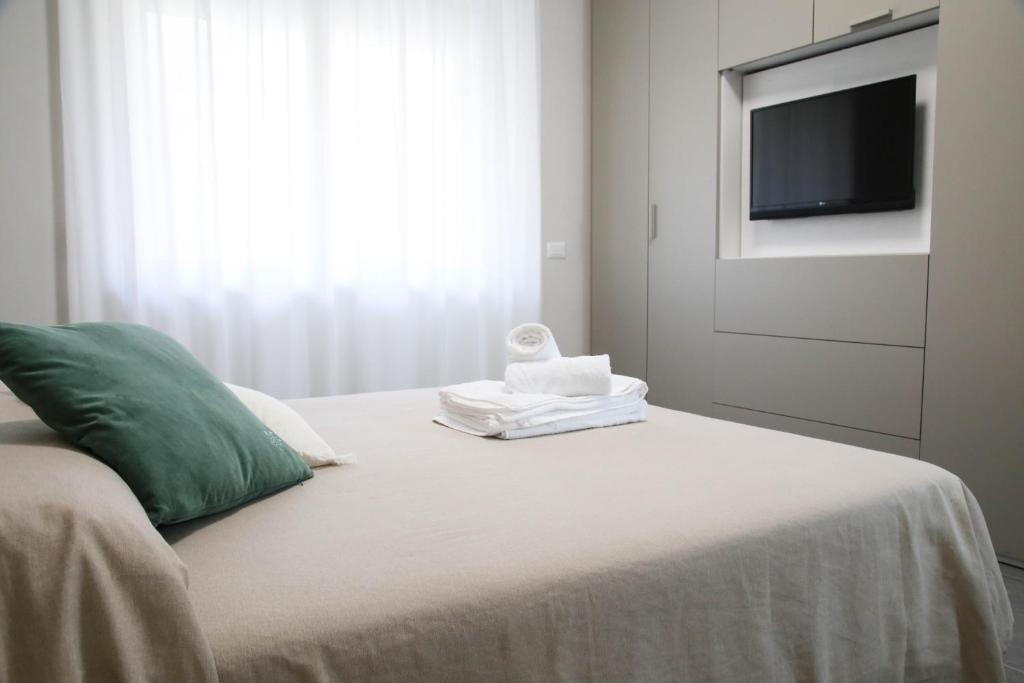 a bedroom with a bed with a flat screen tv at Casa Grande in Crotone