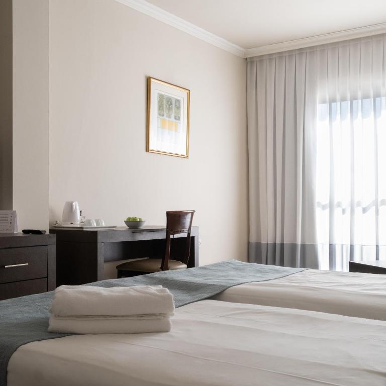 Postel nebo postele na pokoji v ubytování Kfar Maccabiah Business & Sport Hotel