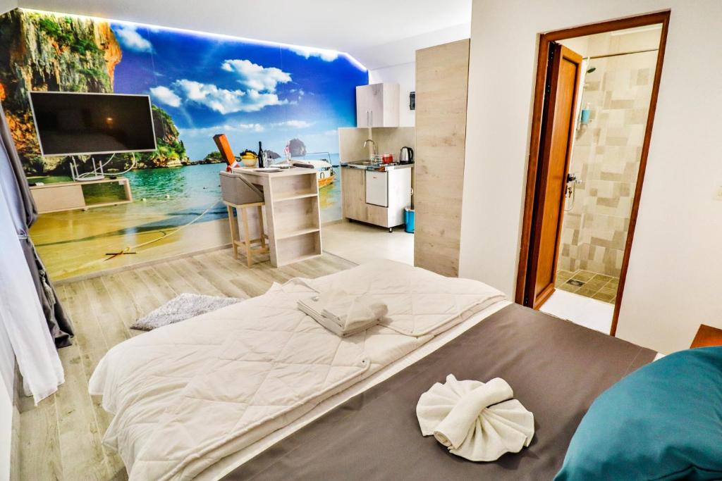 a bedroom with a large bed with a painting on the wall at Simo apartments airport Podgorica in Podgorica