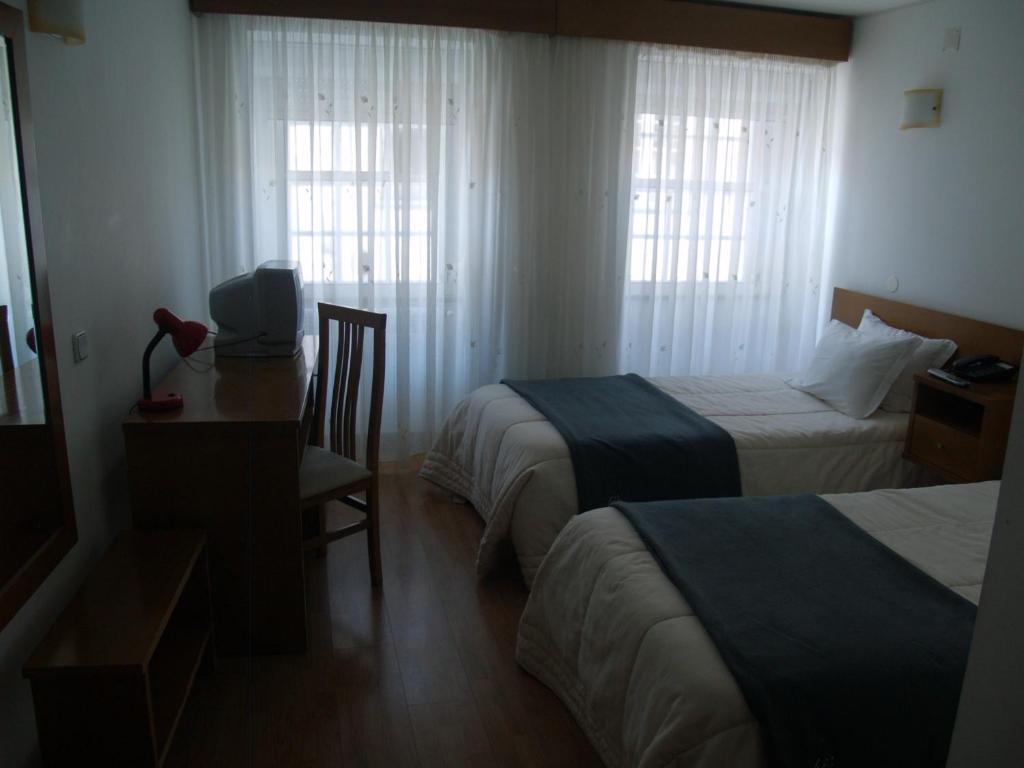 Postel nebo postele na pokoji v ubytování Hotel Santos