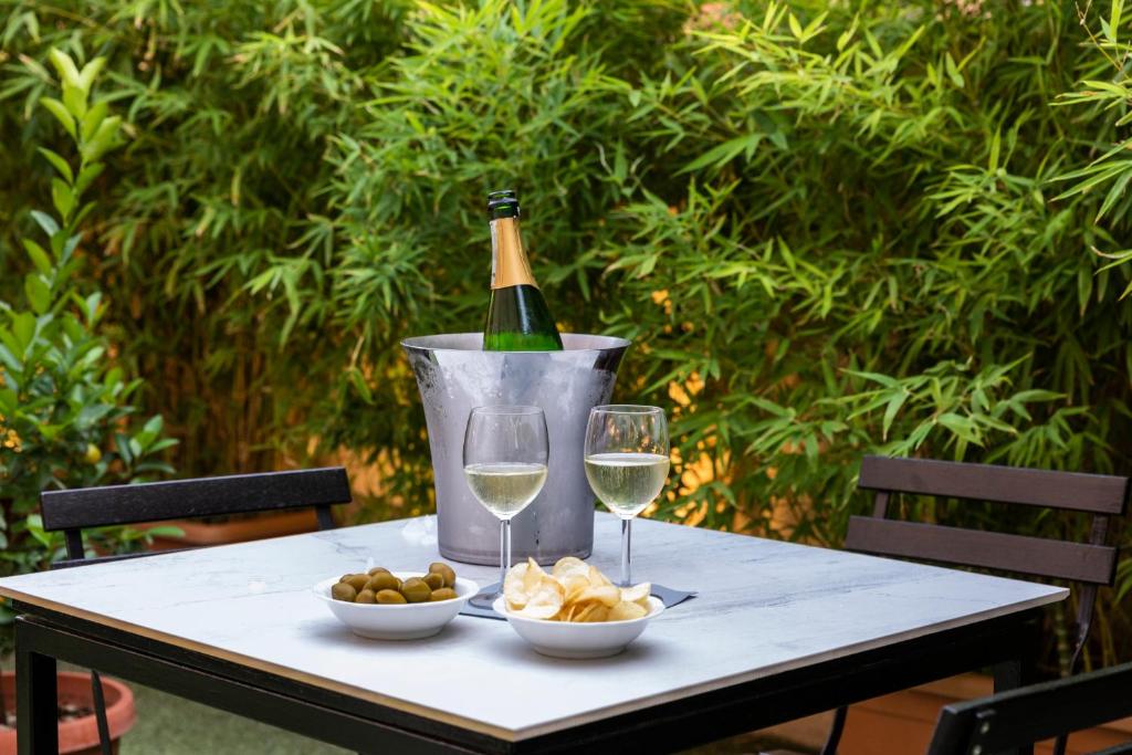 a table with a bottle of wine and two glasses at Hotel Coppede' in Rome