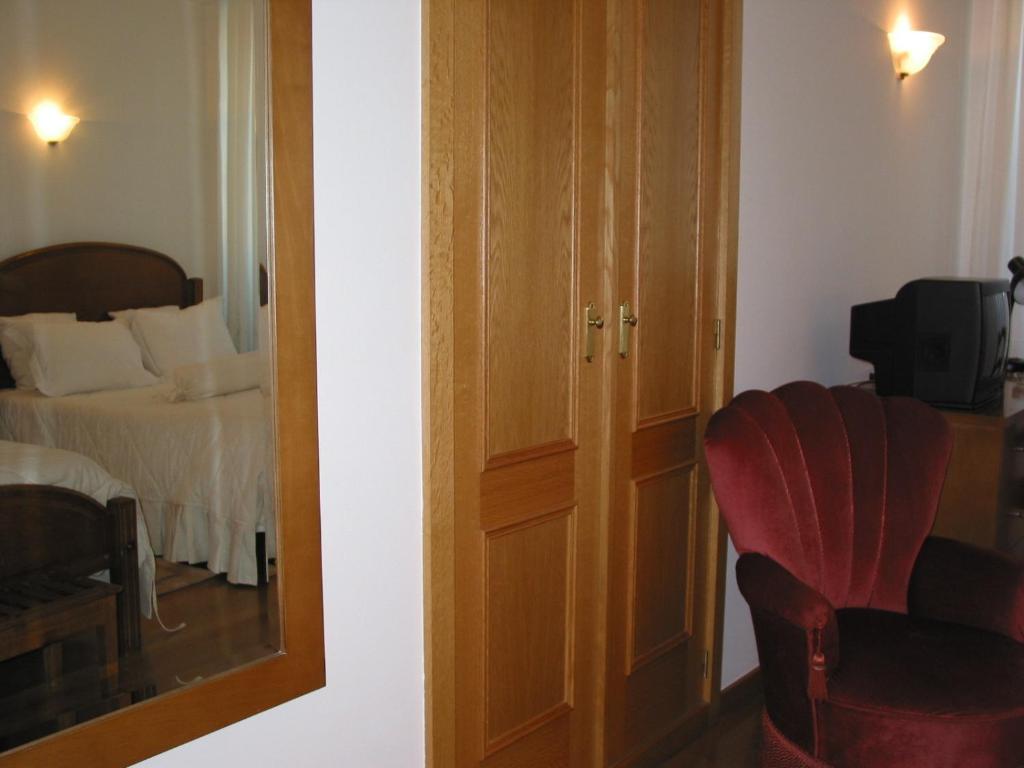Postel nebo postele na pokoji v ubytování Hotel Santos