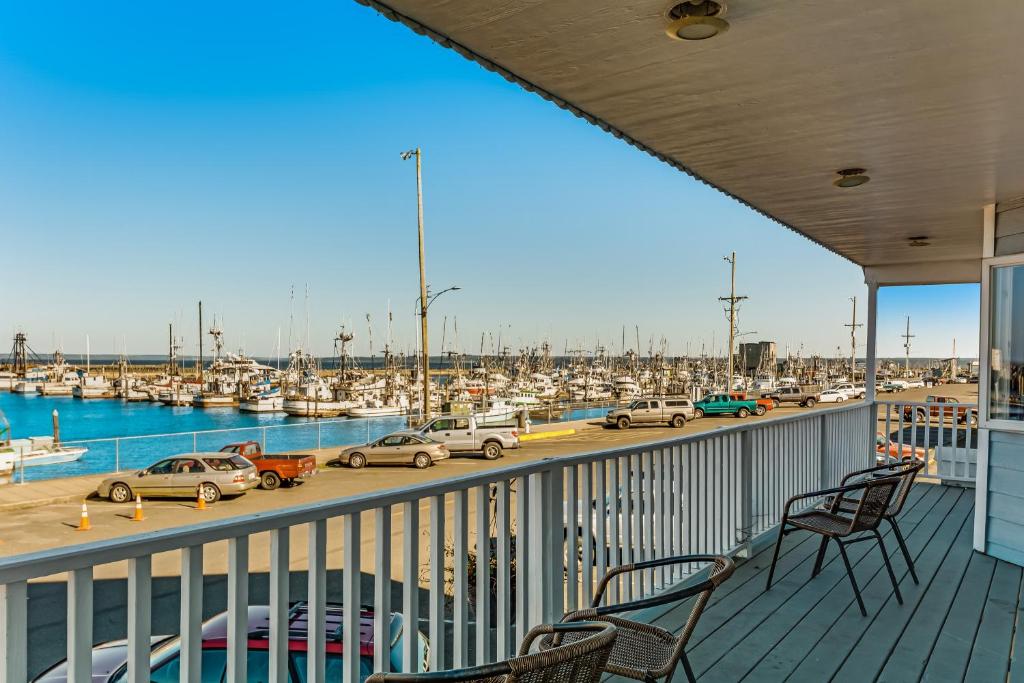 a balcony with chairs and cars on a marina at Westport Marina View in Westport