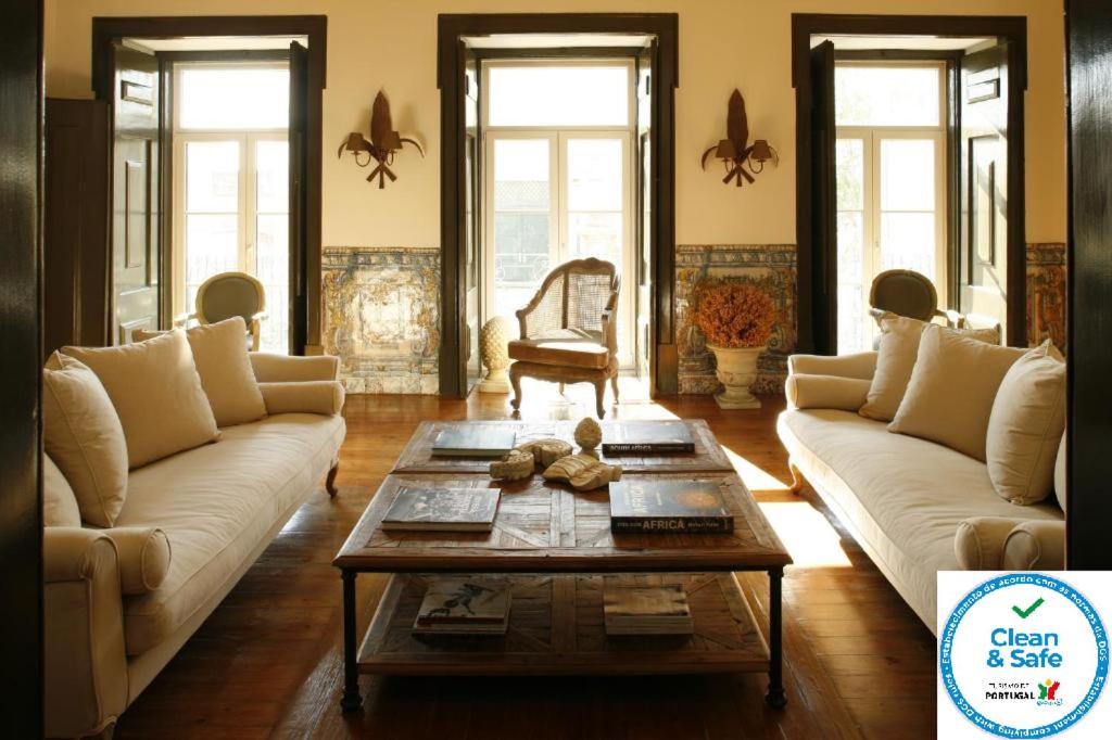 a living room with two couches and a coffee table at Palacio Ramalhete in Lisbon