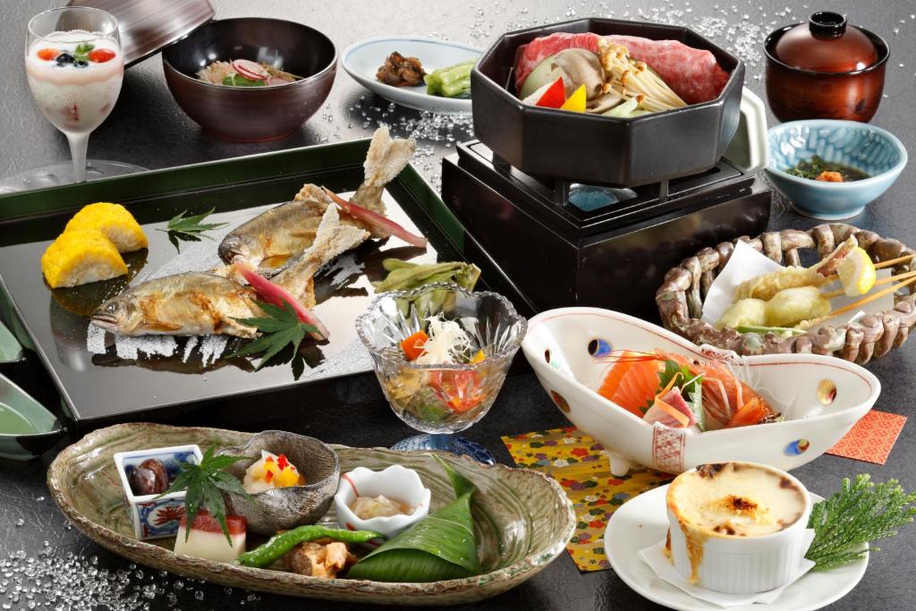 a table with a bunch of different types of food at Wafu-no-Yado MASUYA in Yamanouchi