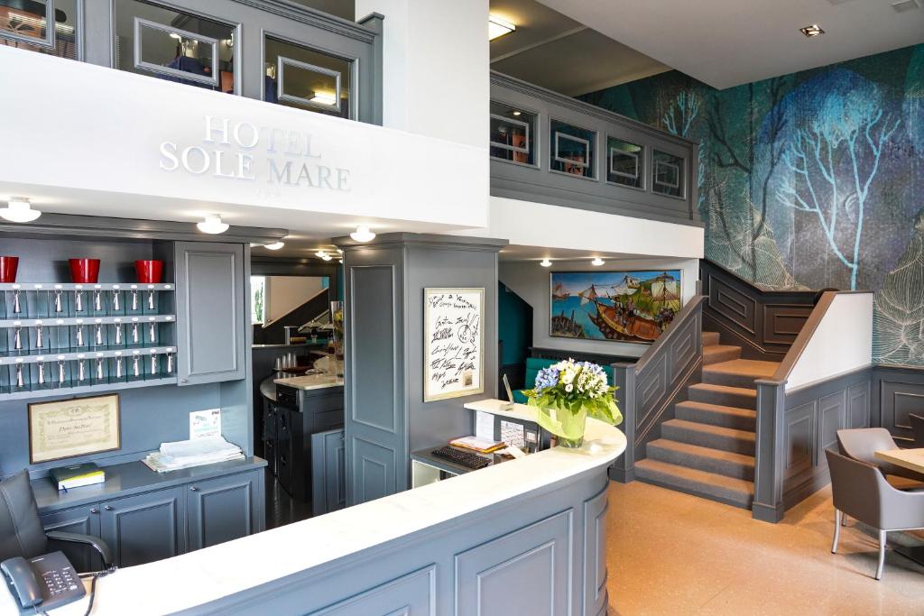 a salon with blue walls and stairs and a counter at Sole Mare in Ventimiglia