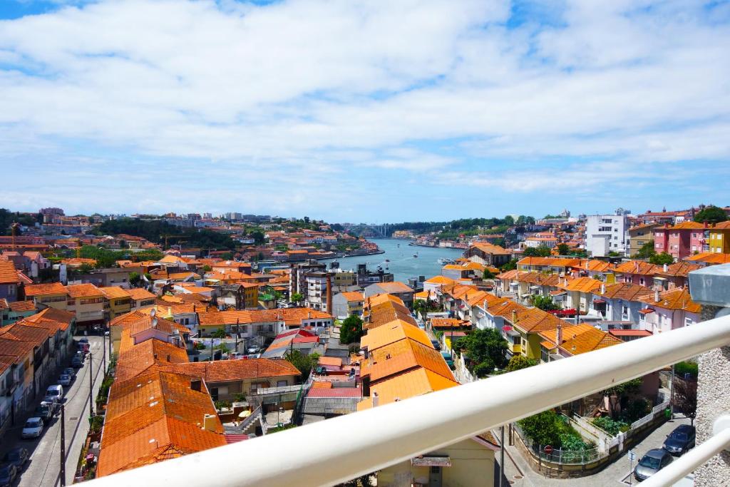 a view of a city with a river and buildings at Porto River Sunset 1st in Vila Nova de Gaia