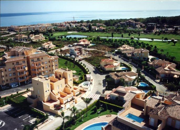 una vista aérea de una ciudad con edificios y el océano en APARTAMENTOS PAR TRES - Oliva Nova, en Oliva