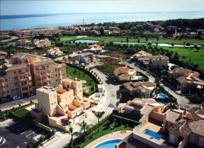 an aerial view of a city with buildings and the ocean at APARTAMENTOS PAR TRES - Oliva Nova in Oliva