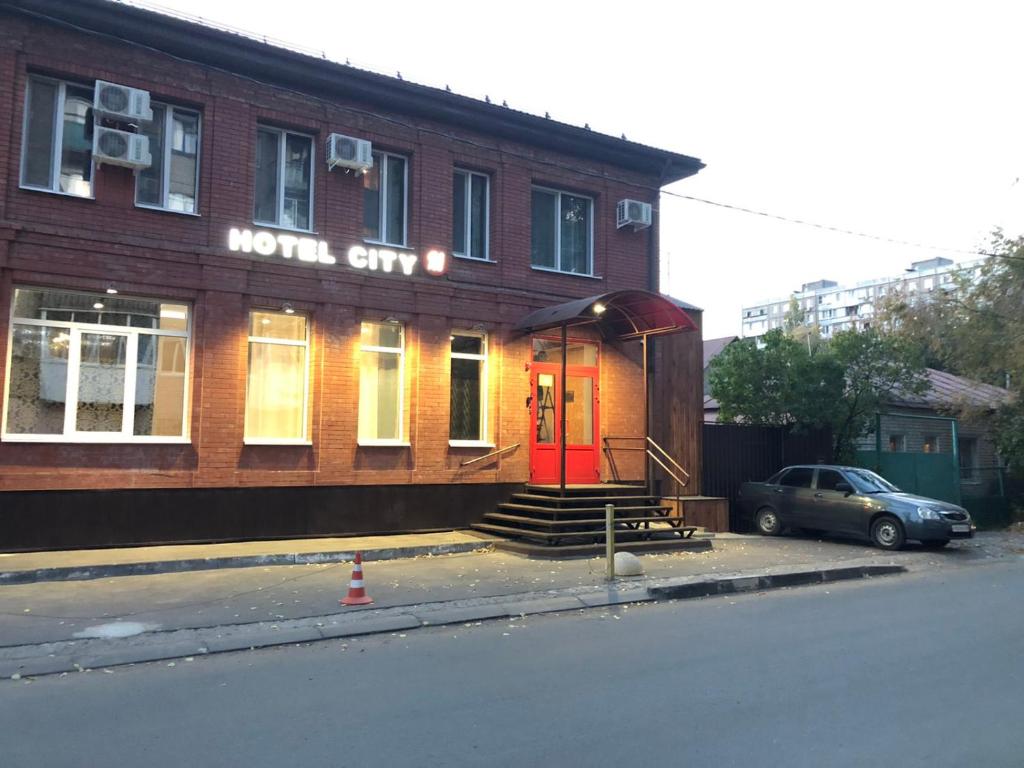 a building with a red door on a street at HOTEL CITY M in Saratov