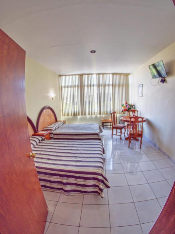 Postel nebo postele na pokoji v ubytování Hotel Plaza Sahuayo