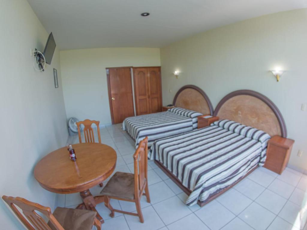 Postel nebo postele na pokoji v ubytování Hotel Plaza Sahuayo