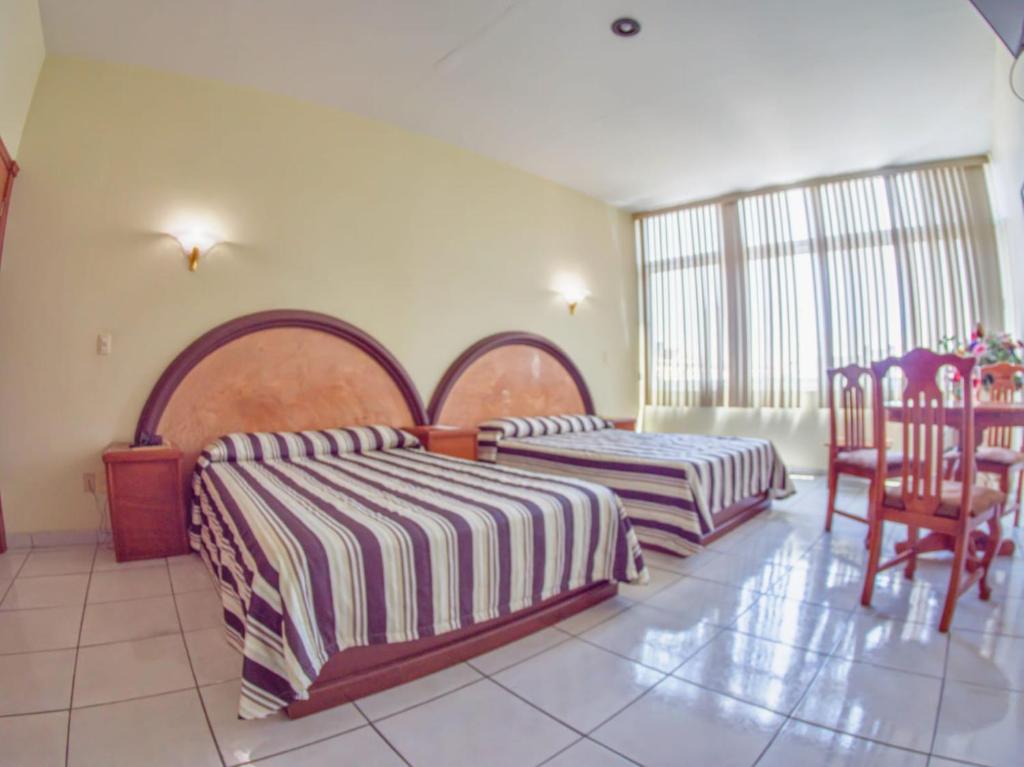 Postel nebo postele na pokoji v ubytování Hotel Plaza Sahuayo