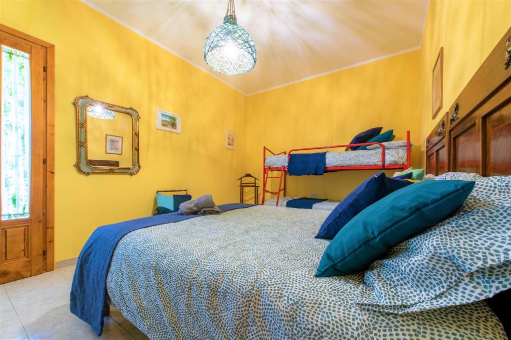A bed or beds in a room at Hostly - Country House Donoratico - ONLY FOR FAMILIES