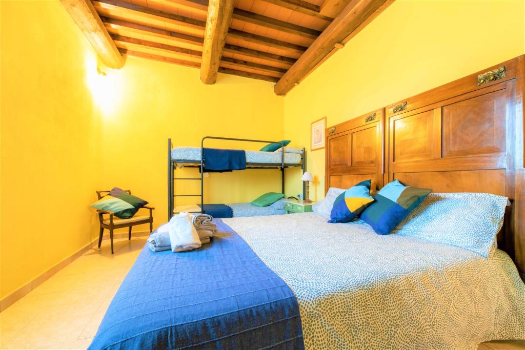 A bed or beds in a room at Hostly - Country House Donoratico - ONLY FOR FAMILIES