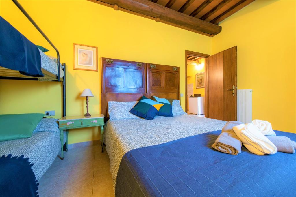 A bed or beds in a room at Hostly - Country House Donoratico - ONLY FOR FAMILIES