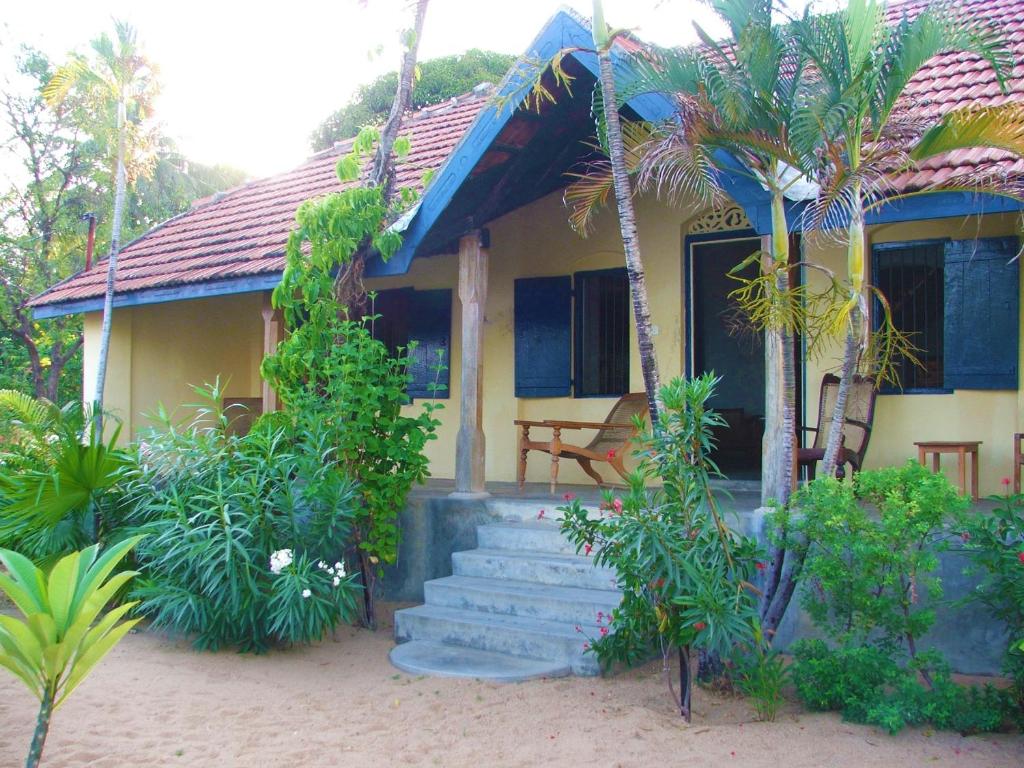a house with a staircase in front of it at 15LMD Villa in Front of the Lagoon in Batticaloa