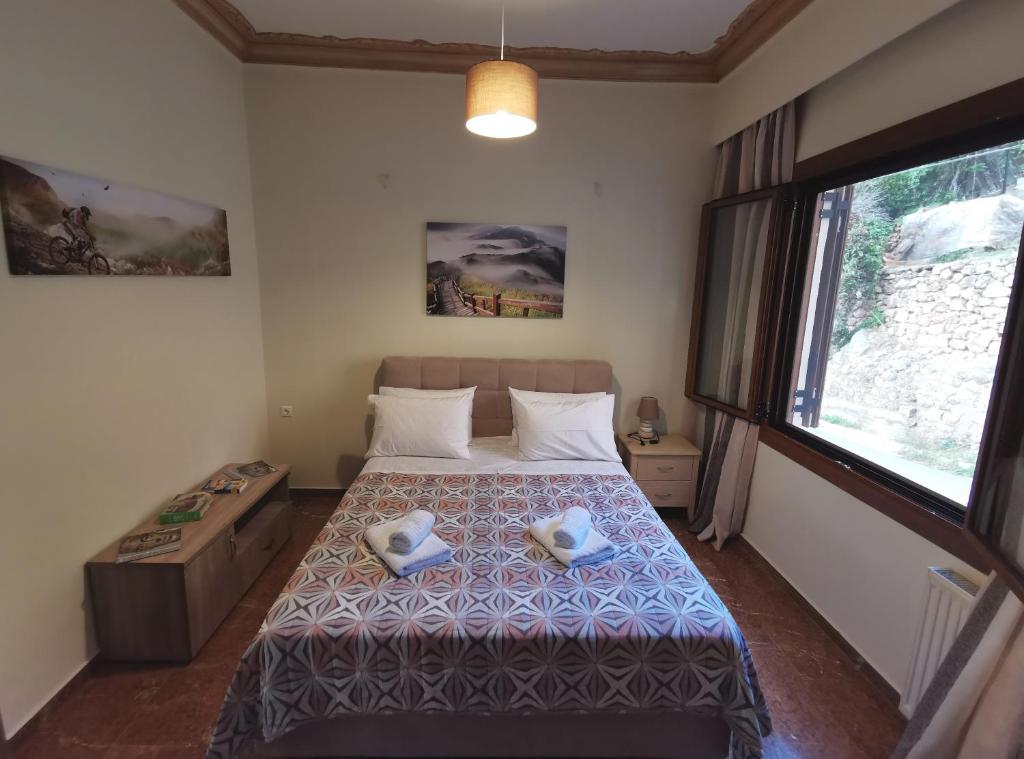 a bedroom with a bed with two towels on it at Delphic Horizons in Delphi